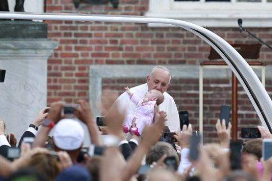 Pope Francis kisses a baby at Independence Hall in Philadelphia on Saturday, Sept. 26, 2015. (David Swanson/Philadelphia Inquirer/TNS via Getty Images)