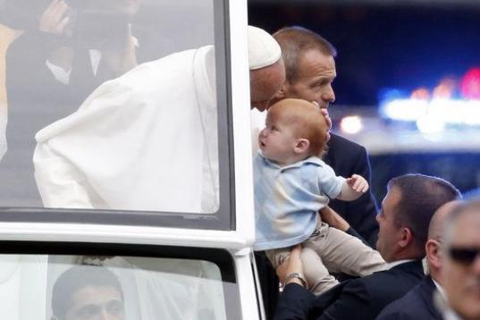 PHILADELPHIA, PA - SEPTEMBER 27: Pope Francis blesses a baby in the Popemobile during a parade September 27, 2015 in Philadelphia, Pennsylvania. Pope Francis is in Philadelphia for the last leg of his six-day visit to the U.S.  (Photo bt Alex Br...