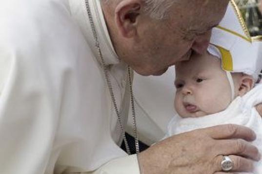In this photo taken on Saturday Sept. 26, 2015 Pope Francis kisses a baby on his way to the Indipendence Mall in Philadelphia. (L'Osservatore Romano/Pool Photo via AP)