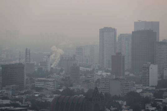 Buildings shrouded in smog, are pictured as Mexico's government ordered schools in and around Mexico City to be closed on Thursday due to elevated levels of pollution, in Mexico City, Mexico May 16, 2019. REUTERS/Henry Romero