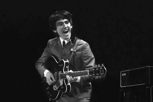 This February 11, 1964 photo provided by Christie's auction house, from a collection of photos of The Beatles shot by photographer Mike Mitchell at the Washington Coliseum in Washington, D.C., shows George Harrison during the group's first US co...