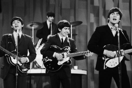 FILE - In this Feb. 9, 1964 file photo, The Beatles perform on the CBS "Ed Sullivan Show" in New York. Ringo Starr plays drums, rear, and playing guitars from left are Paul McCartney, George Harrison and John Lennon. An estimated 73 million Amer...