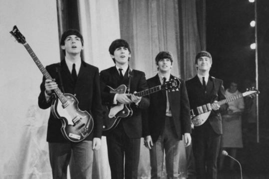 1963:  Pop group The Beatles take a bow on stage after performing in the Royal Command Performance at the Prince of Wales Theatre.  (Photo by Fox Photos/Getty Images)