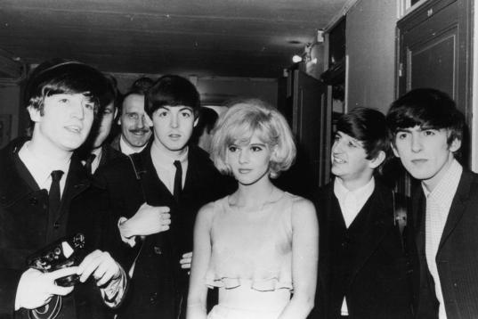 18th January 1964:  The British pop band The Beatles, left to right, John Lennon (1940 - 1980), Paul McCartney, Ringo Starr and George Harrison (1943 - 2001), after their Paris show, with their co-star the French singer Sylvie Vartan.  (Photo by...