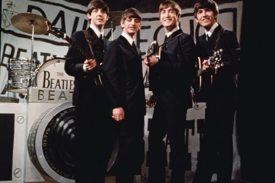25th November 1963:  Liverpudlian beat combo The Beatles, from left to right Paul McCartney, Ringo Starr, John Lennon (1940 - 1980), and George Harrison (1943 - 2001), performing in front of a camera-shaped drum kit on Granada TV's Late Scene Ex...