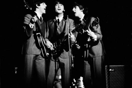 British pop group the Beatles perform on stage, 1964. (L-R) Paul McCartney, John Lennon (1940 - 1980), and George Harrsion (1943 - 2001). Drummer Ringo Starr is hidden behind them. (Photo by Ralph Morse/Time Life Pictures/Getty Images)