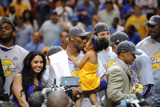 Kobe Bryant of the Los Angeles Lakers celebrates victory with his family following Game 5 of the NBA Finals against the Orlando Magic at Amway Arena on June 14, 2009 in Orlando, Florida. The Lakers won the National Basketball Association champio...
