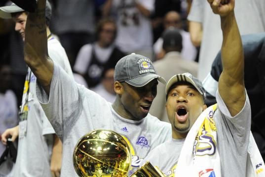 Kobe Bryant (L) and Derek Fisher celebrate after defeating the Orlando Magic in Game 5 of the NBA finals at Amway Arena on June 14, 2009 in Orlando, Florida. The Lakers won the National Basketball Association championships defeating Orlando 99-8...