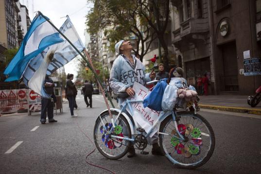 En esta foto del 9 de octubre de 2013, un partidario de la presidenta Cristina Fernández se encuentra frente al Hospital Favaloro con su bicicleta decorada con la bandera argentina en Buenos Aires. Un parte médico del Favaloro el viernes 11 de...