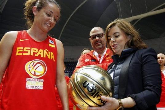 La vicepresidenta del Gobierno, Soraya Sáenz de Santamaría recibe un balon firmado por todas las jugadoras de la selección nacional de baloncesto femenino,