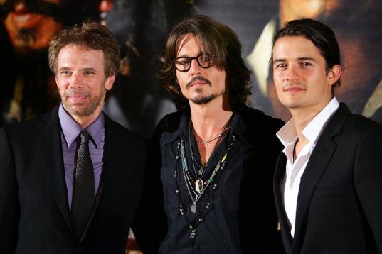 El actor junto al productor Jerry Bruckheimer y a su compañero de reparto, Orlando Bloom, en la premiere de la segunda película de Piratas del Caribe