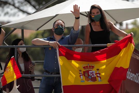 MADRID, SPAIN - MAY 23: Supporters of Far right wing VOX party, holding Spanish flags take part on an in-vehicle protest against the Spanish government's struggle policy against the novel coronavirus (Covid-19) pandemic on May 23, 2020 in Madrid...
