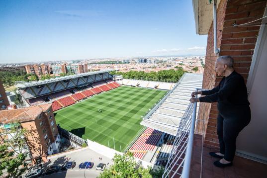 MADRID, SPAIN - JUNE 09: An older woman looks from her balcony at the Vallecas Stadium in the run-up to the outcome of the Liga Smartbank football match between Rayo Vallecano and Albacete BP,on June 09, 2020 in Madrid, Spain. The match was aban...