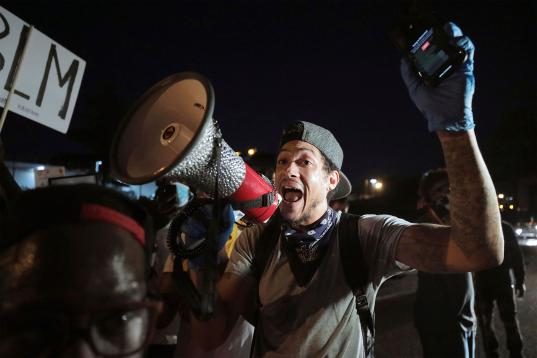 Protestors celebrate after eluding authorities and stopping traffic along Interstate 55 in Memphis, Tennessee, Sunday, May 31, 2020, during a protest over the death of George Floyd on May 25. (Patrick Lantrip/Daily Memphian via AP)