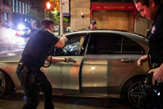 Police stop a driver in the SoHo shopping district Sunday, May 31, 2020, in New York. Protests were held throughout the city over the death of George Floyd, who died May 25 after he was pinned at the neck by a Minneapolis police officer. (AP Pho...