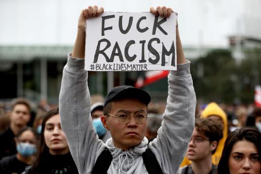 AUCKLAND, NEW ZEALAND - JUNE 01: Protestors march down Queen Street on June 01, 2020 in Auckland, New Zealand. The rally was organised in solidarity with protests across the United States following the killing of an unarmed black man George Floy...