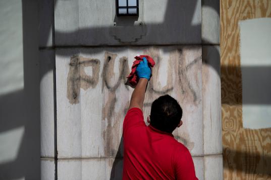 EDITORS NOTE: Graphic content / A worker removes graffiti near the White House after a third night of violent protests over the death of George Floyd June 1, 2020, in Washington, DC. - Police fired tear gas outside the White House late Sunday as...