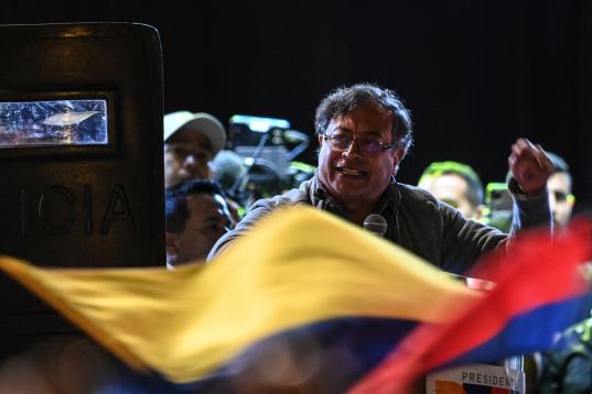 Colombian presidential left-wing candidate Gustavo Petro, speaks flanked by bodyguards holding bulletproof shields during his closing campaign rally at the Bolivar square in Bogota, Colombia on May 22, 2022. - Petro is leading the polls for the ...