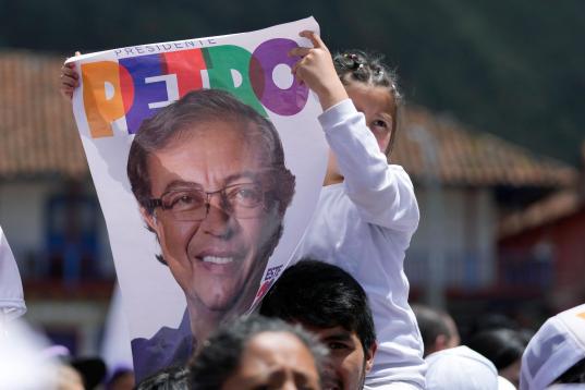 A girl holds a poster of Historical Pact coalition presidential candidate Gustavo Petro, during a closing campaign rally in Zipaquira, Colombia, Sunday, May 22, 2022. Elections are set for May 29. (AP Photo/Fernando Vergara)