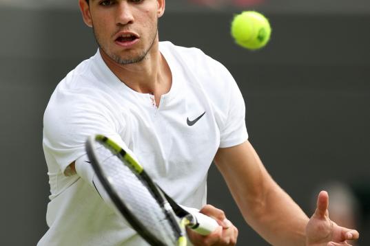 Carlos Alcaraz hits a return during the men's singles third round match between Carlos Alcaraz of Spain and Oscar Otte of Germany at Wimbledon Tennis Championship in London, Britain, on July 1, 2022. (Photo by Han Yan/Xinhua via Getty Images)