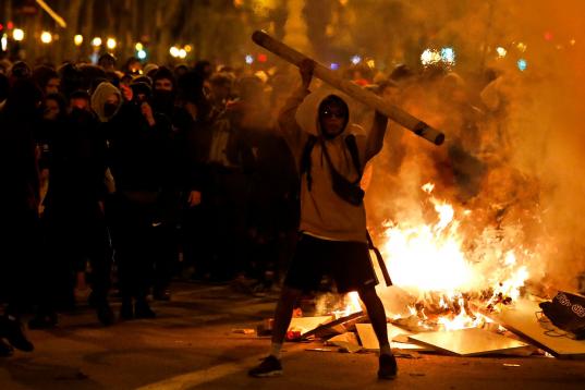 Protestors start fires in the street during clashes with police in Barcelona, Spain, Wednesday, Oct. 16, 2019. Spain's government said Wednesday it would do whatever it takes to stamp out violence in Catalonia, where clashes between regional ind...