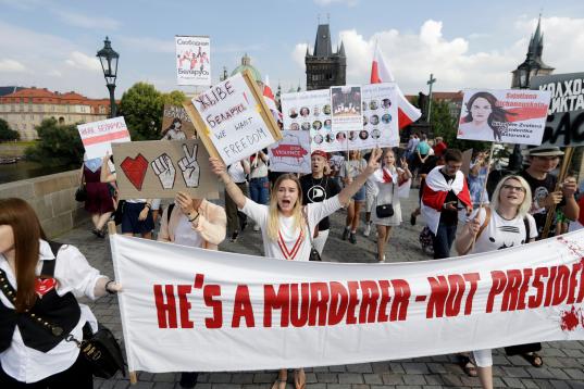 Demonstrators shout slogans as hundreds of people, among them many Belarusians, march in support of Belarusian demonstrators facing a brutal crackdown from the government of President Alexander Lukashenko across the Charles Bridge in Prague, Cze...