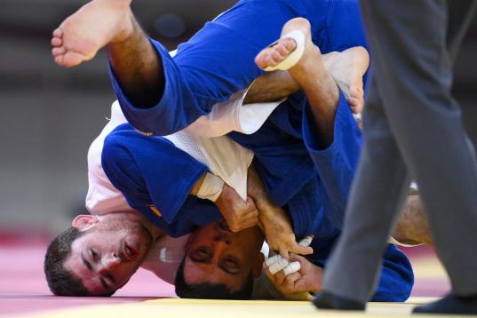 Spain's Alberto Gaitero Martin (white) competes with Ukraine's Georgii Zantaraia during their judo men's -66kg elimination round bout during the Tokyo 2020 Olympic Games at the Nippon Budokan in Tokyo on July 25, 2021. (Photo by Franck FIFE / AF...