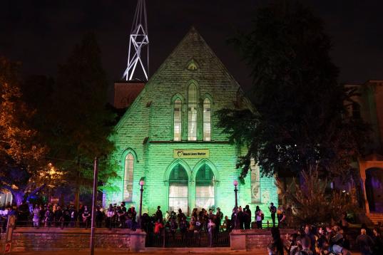 Protesters wait outside the First Unitarian church, Thursday, Sept. 24, 2020, in Louisville, Ky. Authorities pleaded for calm while activists vowed to fight on Thursday in Kentucky's largest city, where a gunman wounded two police officers durin...