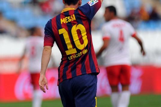 Barcelona's Argentinian forward Lionel Messi celebrates after scoring during the Spanish league football match UD Almeria vs FC Barcelona at the Juegos Mediterraneos stadium in Almeria on September 28, 2013.   AFP PHOTO/ JORGE GUERRERO        (P...