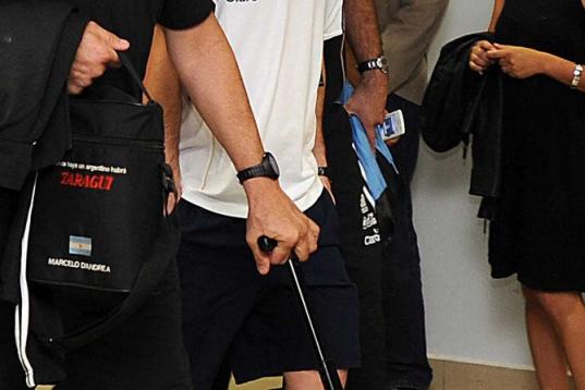 Barcelona's Lionel Messi from Argentina, center, walks to a waiting vehicle upon his arrival at La Aurora airport in Guatemala City, early Wednesday, June 12, 2013. A tax fraud lawsuit has been filed by a Spanish state prosecutor of Catalonia ag...