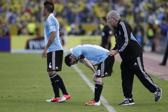Argentina's coach Alejandro Sabella, right, pats Argentina's Lionel Messi on the back during a 2014 World Cup qualifying soccer match with Ecuador in Quito, Ecuador, Tuesday, June 11, 2013. (AP Photo/Dolores Ochoa).