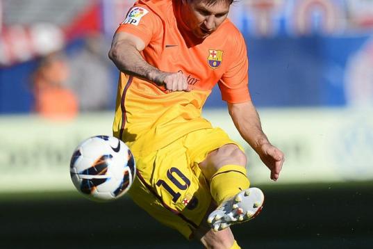 Barcelona's Argentinian forward Lionel Messi kicks the ball during the Spanish league football match Atletico de Madrid vs Barcelona on May 12, 2013 at Vicente Calderon stadium in Madrid. AFP PHOTO/ PIERRE-PHILIPPE MARCOU        (Photo credit sh...