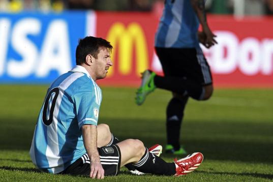 Argentina's Lionel Messi sits on the pitch during a World Cup 2014 qualifying soccer match against Bolivia in La Paz, Bolivia, Tuesday, March 26, 2013. (AP Photo/Juan Karita)