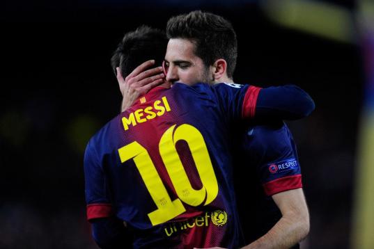 Barcelona's defender Jordi Alba, right, hugs teammate Lionel Messi, from Argentina, after he scored their second goal during the Champions League round of 16 second leg soccer match between FC Barcelona and AC Milan at Camp Nou stadium, in Barce...