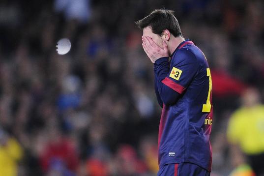 Barcelona's Lionel Messi from Argentina reacts during a Copa del Rey soccer match between FC Barcelona and Real Madrid at the Camp Nou stadium in Barcelona, Spain, Tuesday, Feb. 26, 2013. (AP Photo/Manu Fernandez)