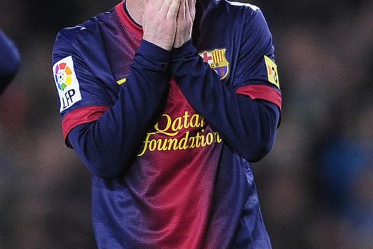 Barcelona's Lionel Messi from Argentina reacts during a Copa del Rey soccer match between FC Barcelona and Real Madrid at the Camp Nou stadium in Barcelona, Spain, Tuesday, Feb. 26, 2013. (AP Photo/Manu Fernandez)