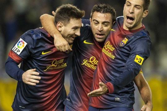 VALLADOLID, SPAIN - DECEMBER 22:  Xavi Hernandez (C) of FC Barcelona celebrates with his teammates Lionel Messi (L) and Jordo Alba after scoring against Real Valladolid at Jose Zorrilla on December 22, 2012 in Valladolid, Spain.  (Photo by Victo...