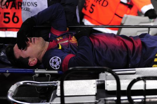 Barcelona's Argentinian forward Lionel Messi leaves the pitch on a stretcher after being injured during the UEFA Champions League football match FC Barcelona vs SL Benfica at the Camp Nou stadium in Barcelona on December 5, 2012. AFP PHOTO  / JO...