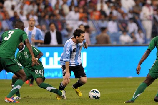 Saudi Arabia's players challenge Argentina's forward Lionel Messi (C) during their friendly football match at King Fahd stadium in the Saudi capital Riyadh on November 14, 2012. The match ended in a goalless draw. AFP PHOTO/FAYEZ NURELDINE      ...