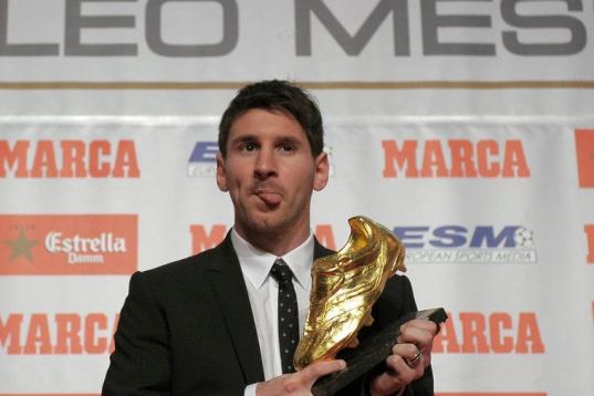 Barcelona's Argentinian forward Lionel Messi poses after receiving the European Golden Boot 2012 award for best European goalscorer of the 2011-2012 season, on October 29, 2012 in Barcelona. Messi scored a Spanish-league record of 50 goals for B...