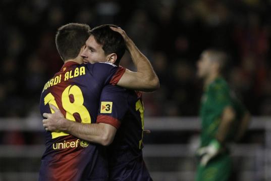 FC Barcelona's Lionel Messi from Argentina, second left, celebrates his goal with Jordi Alba, left, during a Spanish La Liga soccer match against Rayo Vallecano at the Teresa Rivero stadium in Madrid, Spain, Saturday, Oct. 27, 2012. (AP Photo/An...