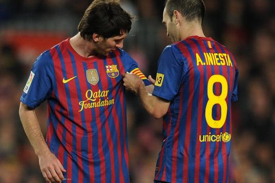 Barcelona's midfielder Andres Iniesta (R) gives the captain's armband to  Barcelona's Argentinian forward Lionel Messi during the Spanish league football match FC Barcelona vs Malaga CF on May 2, 2012 at the Camp Nou stadium in Barcelona. AFP PH...
