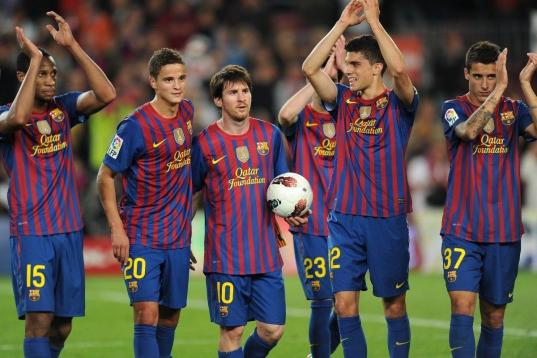 Barcelona's Argentinian forward Lionel Messi (3L) celebraes with teammates after the Spanish league football match FC Barcelona vs Malaga CF on May 2, 2012 at the Camp Nou stadium in Barcelona. Barcelona won 4-1. AFP PHOTO/LLUIS GENE        (Pho...