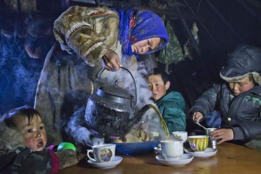 La mujer sirve té a sus hijos en la península de Yamal, noroeste de Siberia, Rusia. 