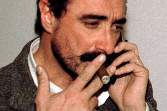 Leading Spanish Radio journalist Carlos Herrera smokes a cigar as he speaks on the phone from his home in Seville March 27 after receiving a letter bomb with 150 grammes of dynamite in a cigar package. The journalist was suspicious the packet wa...
