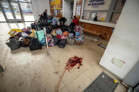 EDITORS NOTE: Graphic content / Evacuees sit near luggage in the train station hall in Kramatorsk, eastern Ukraine, on April 8, 2022, after a rocket attack. - A rocket attack on a train station in the eastern Ukrainian city of Kramatorsk killed ...