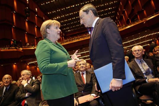 Con Angela Merkel, en 2011.