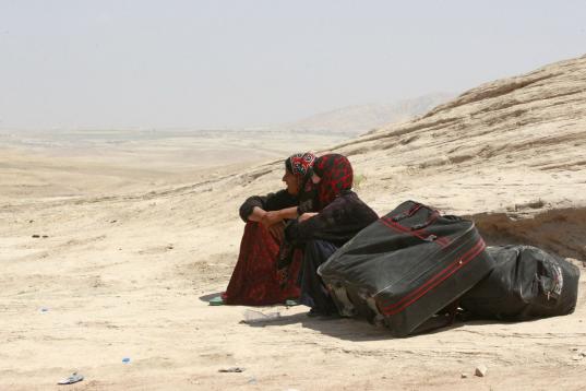 Refugiados sirios descansan al cruzar a Irak en el punto fronterizo de Peshkhabur en Dahuk, 430 kilómetros (260 millas) al noroeste de Bagdad, Irak, el martes 20 de agosto de 2013. Milicias curdas enfrentaron el martes 20 a grupos rebeldes vinc...