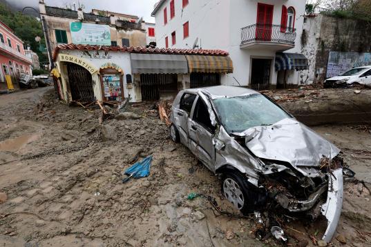 Mud covers streets and cars after heavy rainfall triggered landslides that collapsed buildings and left as many as 12 people missing, in Casamicciola, on the southern Italian island of Ischia, Italy, Saturday, Nov. 26, 2022. Firefighters are wor...