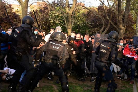 Police clash with people during a demonstration against a political rally of far-right party Vox ahead of regional elections in Madrid's suburb of Vallecas on April 7, 2021. (Photo by JAVIER SORIANO / AFP) (Photo by JAVIER SORIANO/AFP via Getty ...